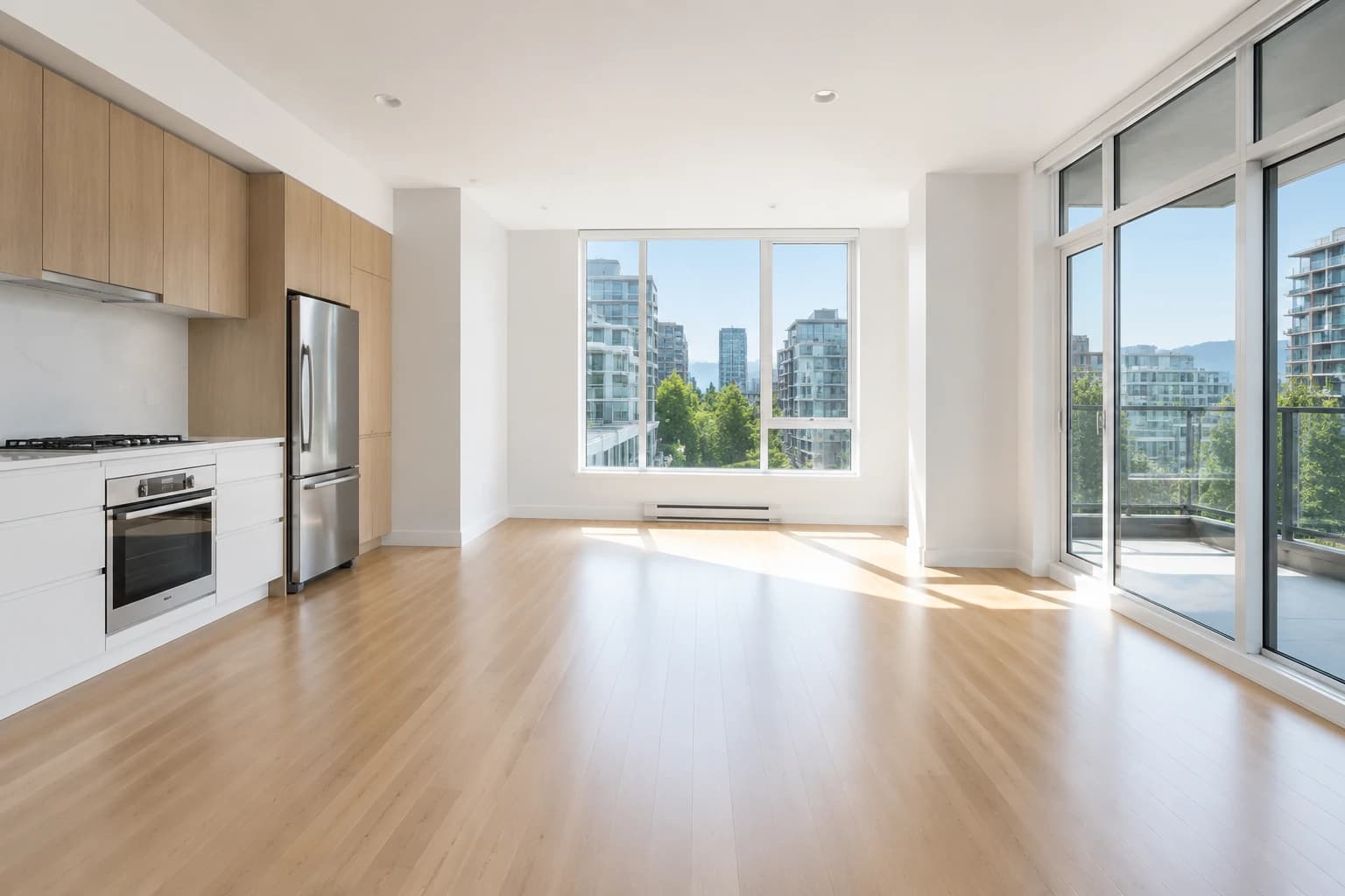 Empty Vancouver one-bedroom after a finished move-out clean, sunlight on bare floors and immaculate baseboards