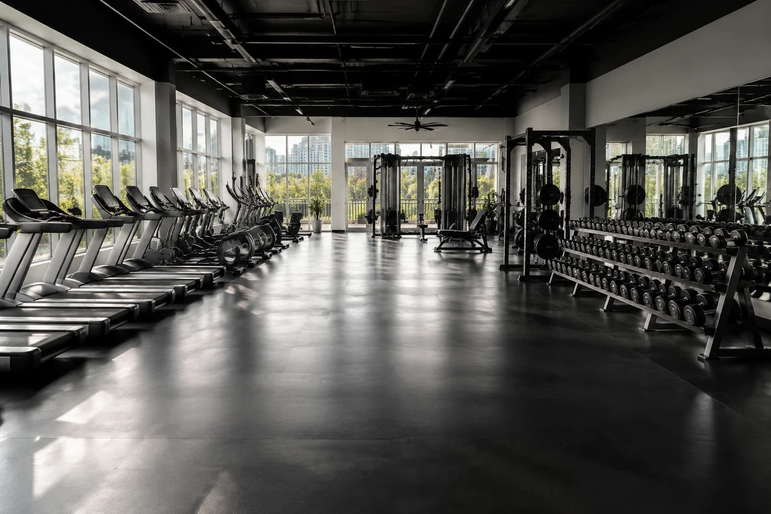 Empty Vancouver gym training floor at opening, freshly cleaned rubber flooring with an even sheen under morning daylight