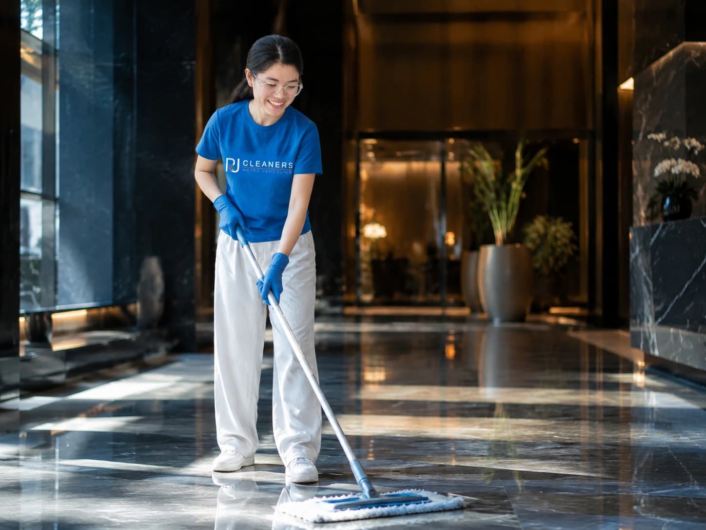 Professional cleaner polishing the floor of a grand corporate lobby