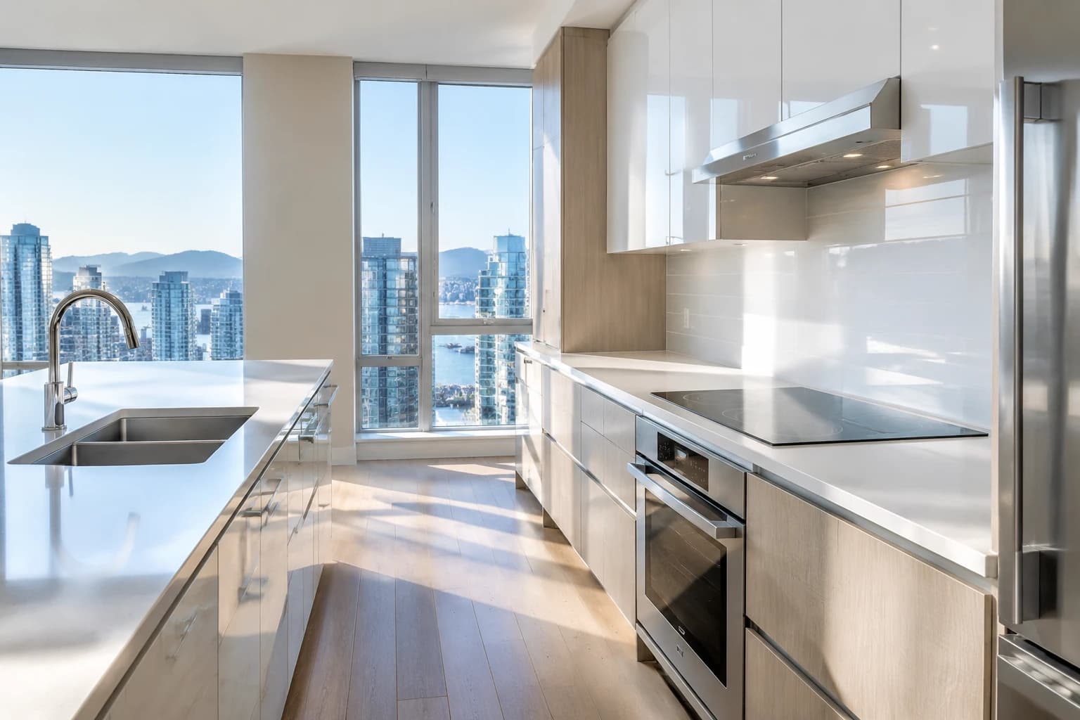 Sunlit Vancouver condo kitchen with mountain views, counters and cabinet fronts spotless after a full deep clean